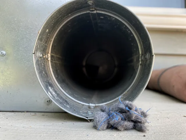 New Haven Dryer Vent Cleaning technician using specialized equipment to clear severe dryer vent blockage in New Haven